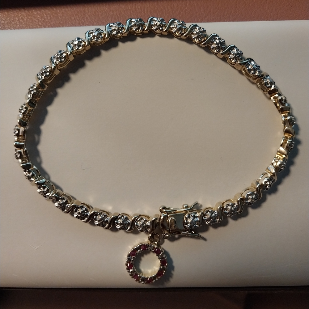 Gold Bracelet With Diamond Accents and Garnet Charm